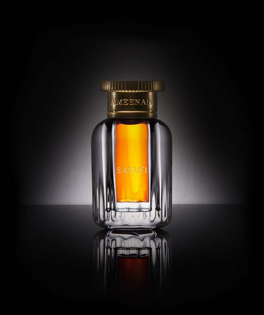 Close-up of Ameenah Sayufi Dehn Al Oud bottle, a bold woody and smoky oud oil extracted from rare Malaccensis wood