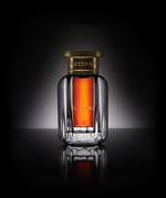 Close-up of Ameenah Malaki Dehn Al Oud bottle, a royal oud oil with woody and vanilla notes, crafted from Thai Aquilaria trees.